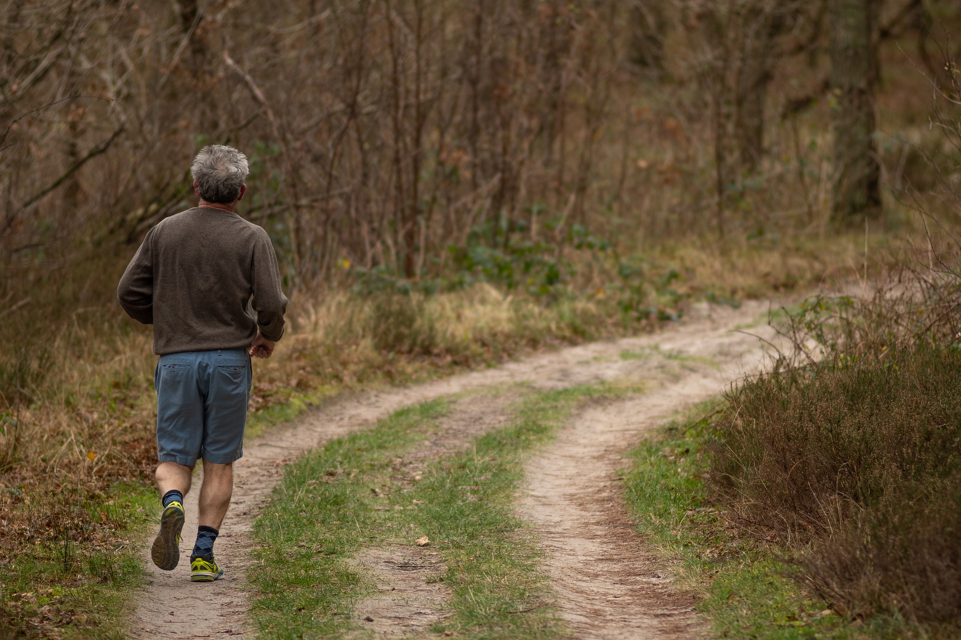 Man jogging on a wooded trail